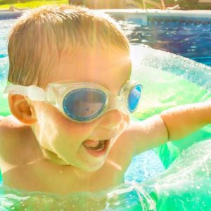 Kid swimming in pool float